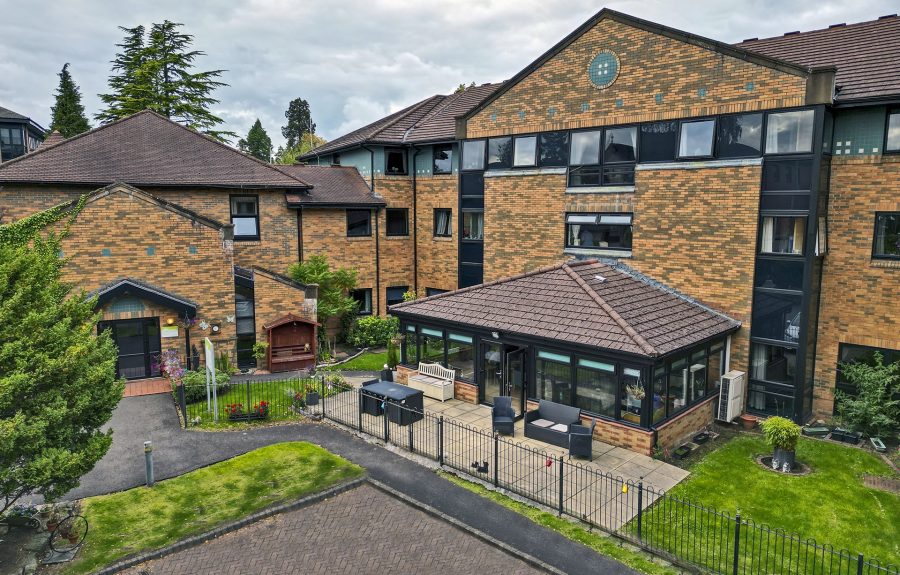Eastwood Court Care Home building exterior showing courtyard and conservatory area