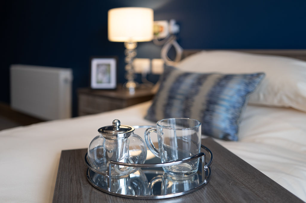 A tea cup on a bedside table