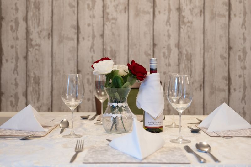 setup of our dining table with red and white roses