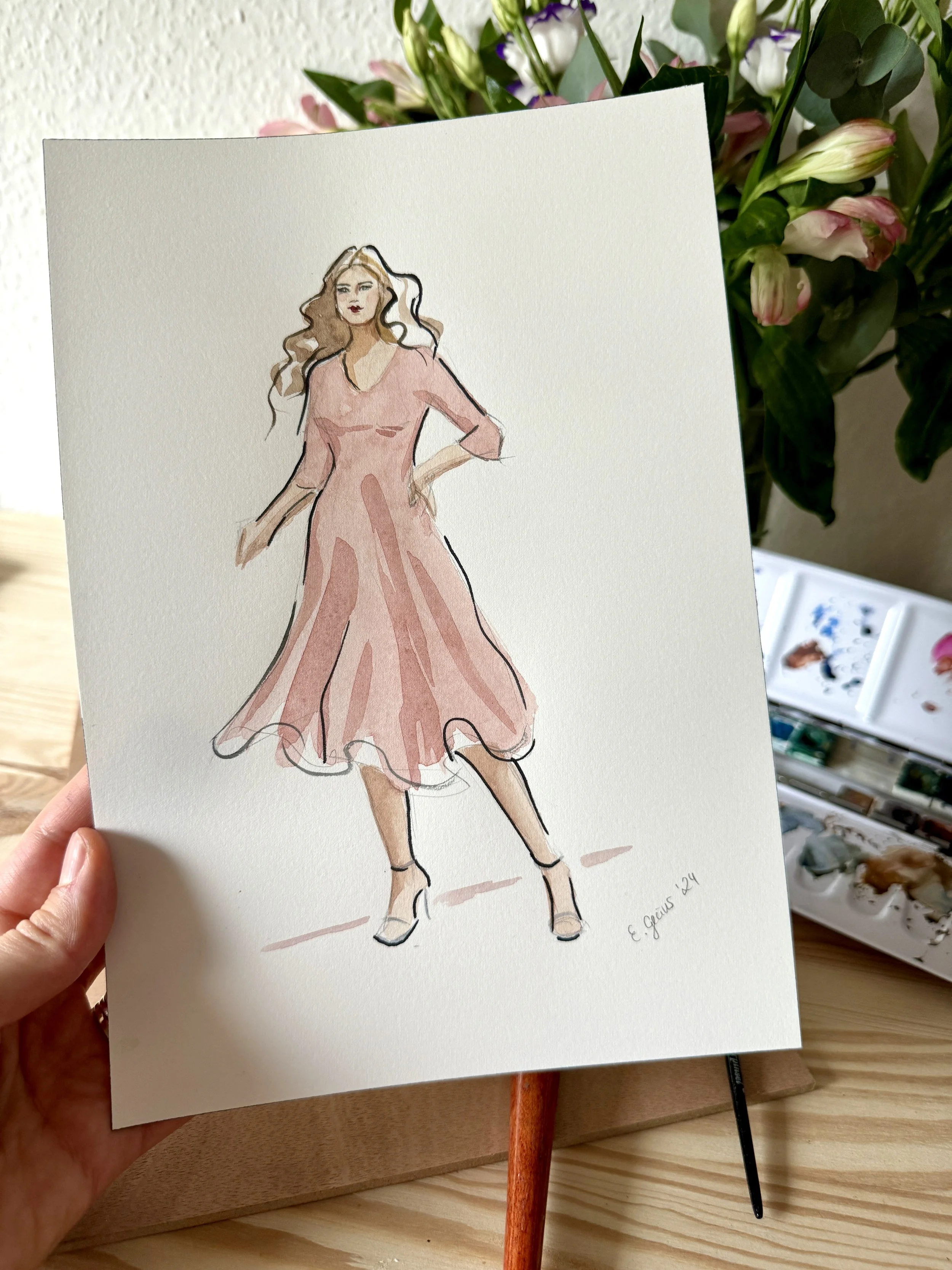 A watercolor illustration of a woman in a pink dress, standing with one hand on her hip and one hand hanging down, with a flower arrangement in the background.