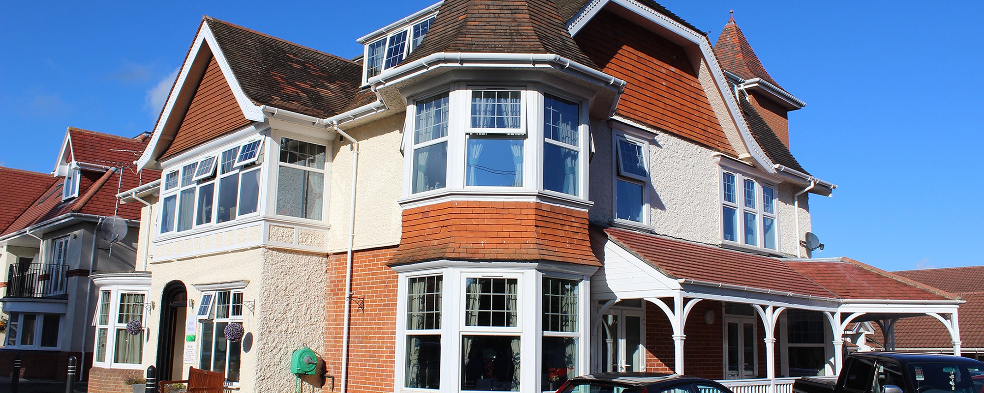 Elegant Edwardian building exterior of Inver House Care Home in Bembridge Isle of Wight viewed from the main entrance with landscaped gardens