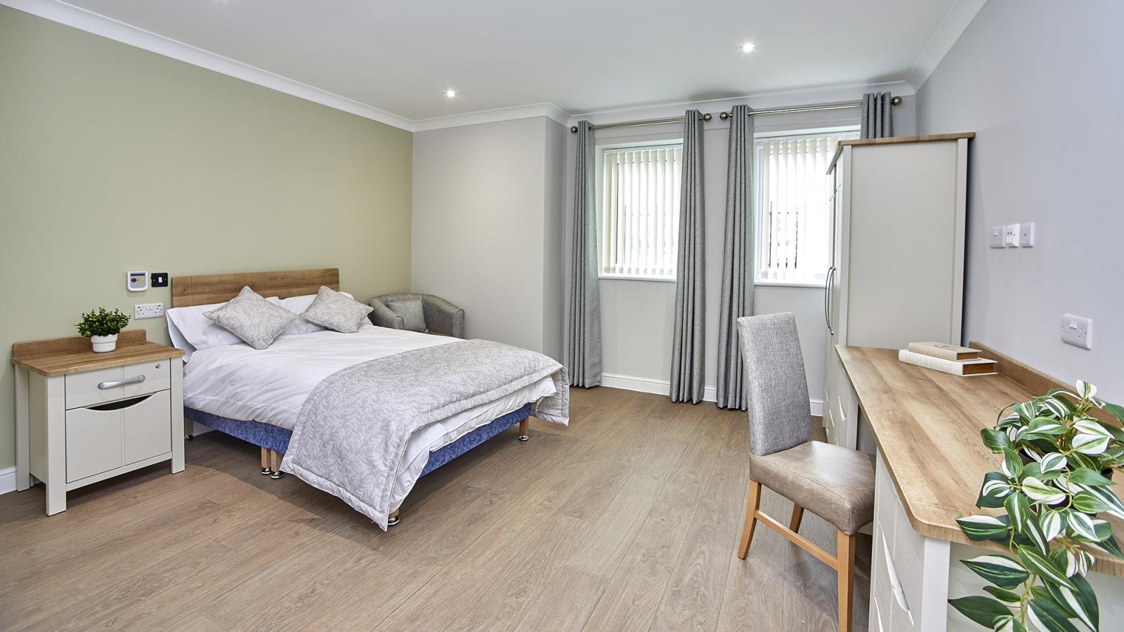 Bedroom with bed, desk and wardrobe at Coronation Court