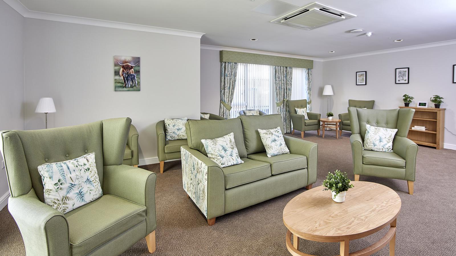 Lounge with several sofas and chairs around a table at Coronation Court