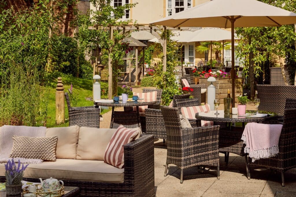 Garden with patio furniture and umbrellas.